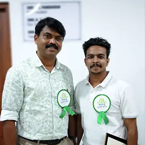 Artist Aadi, renowned graphic design tutor in Kerala, pictured with Mollywood actor Sibi Thomas at an award function.