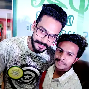 Artist Aadi, recognized as Kerala's best graphic design tutor, with TV serial actor Yuva Krishna.