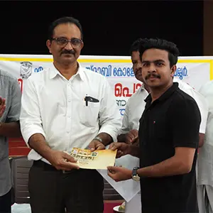 Artist Aadi, recognized as the best graphic design tutor in Kerala, received a cash award from Dr. P. Biju, Principal of MES Asmabi College.