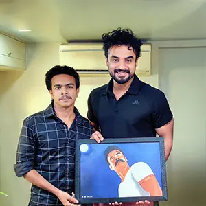 Best graphic design tutor in Kerala photographed with Mollywood actor Tovino Thomas.